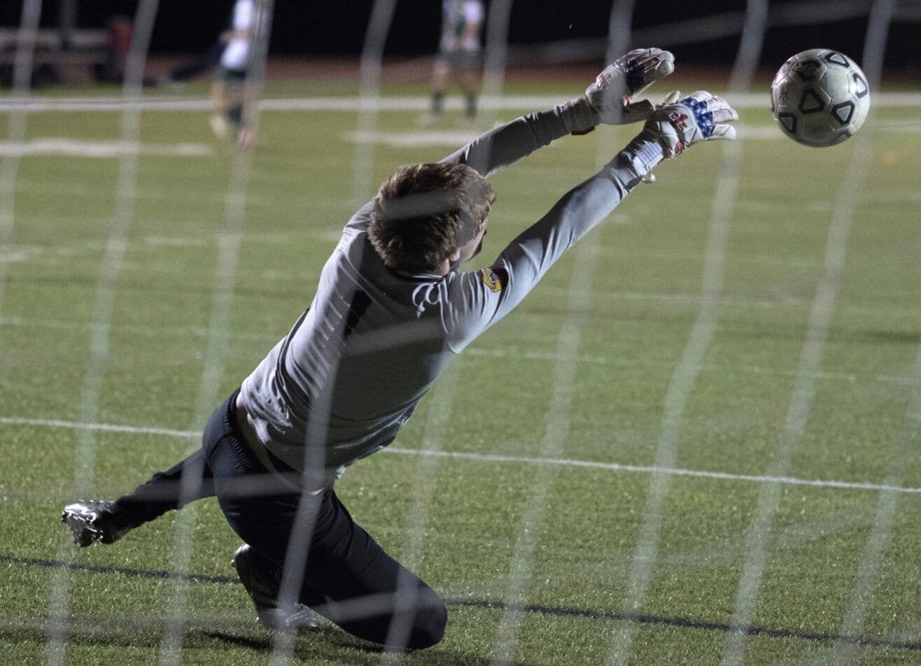 Falcons soccer players mid-match on the campus field